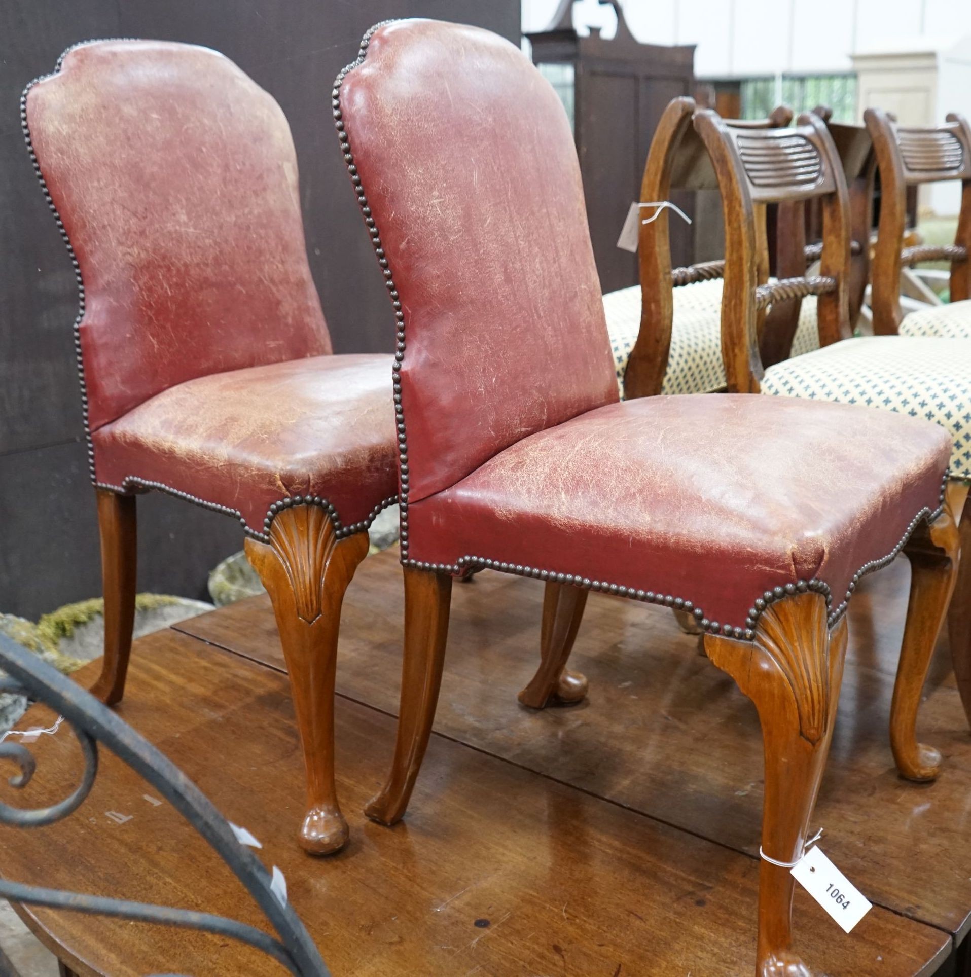 A pair of George II style walnut and red leather side chairs, width 54cm, depth 50cm, height 92cm